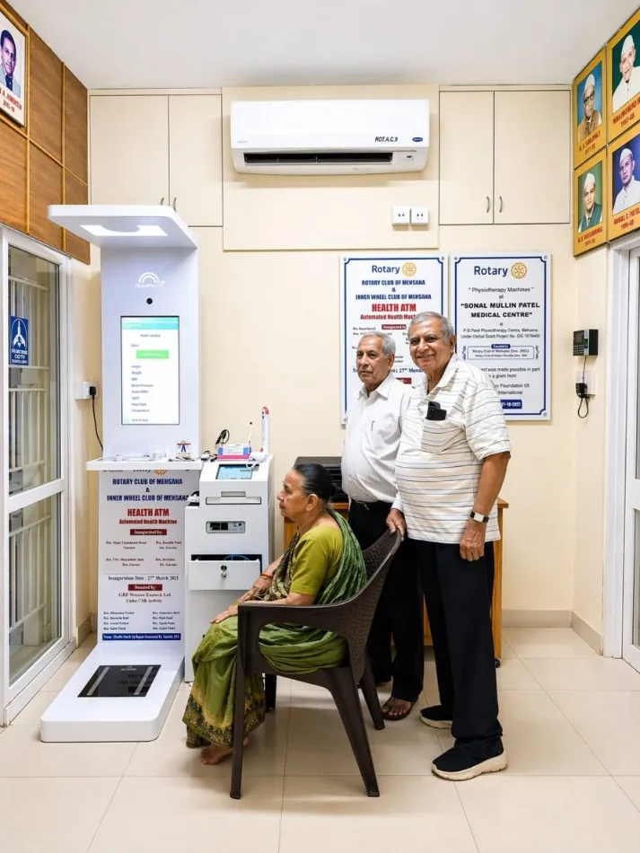 A woman seated at a Cloudspital Health ATM installed with the Rotary Club in Mehsana